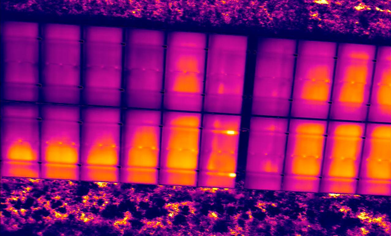 Aerial thermogram of a photovoltaic field with visible hot areas